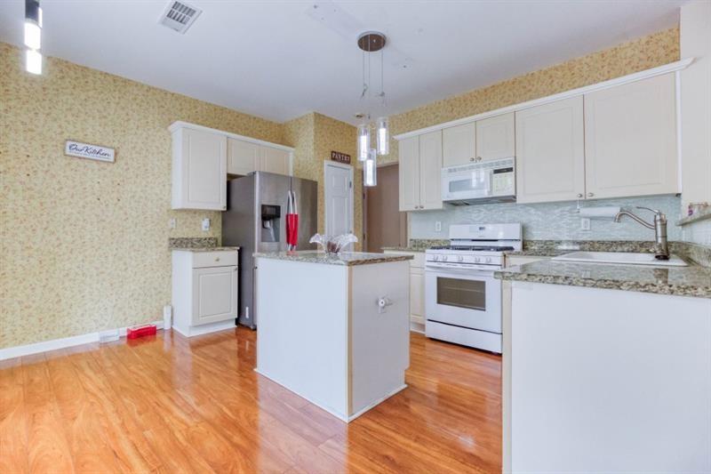 1008 Post Horn Run Lawrenceville, GA 30045 - Photo 14 of 64 a kitchen with stainless steel appliances granite countertop a white cabinets and white appliances