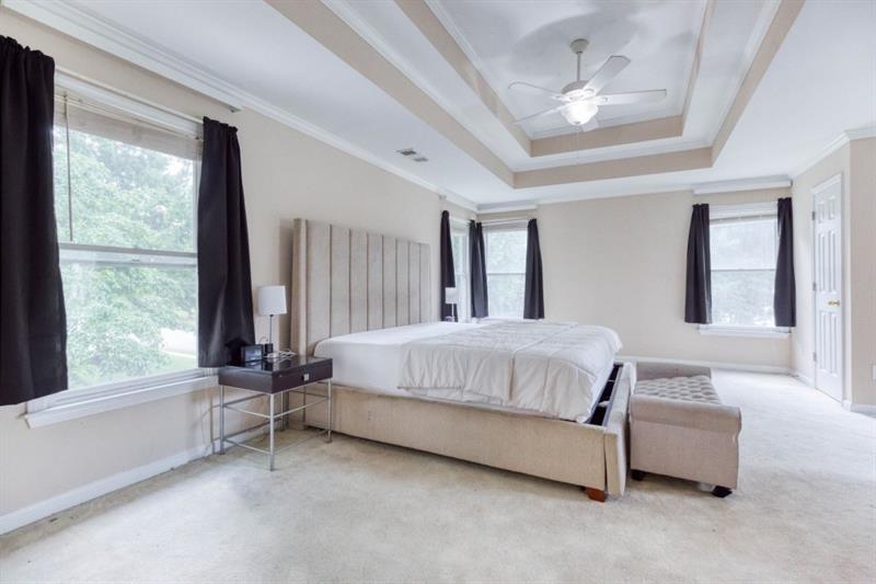 1008 Post Horn Run Lawrenceville, GA 30045 - Photo 17 of 64 a bed sitting in a spacious bedroom next to a window