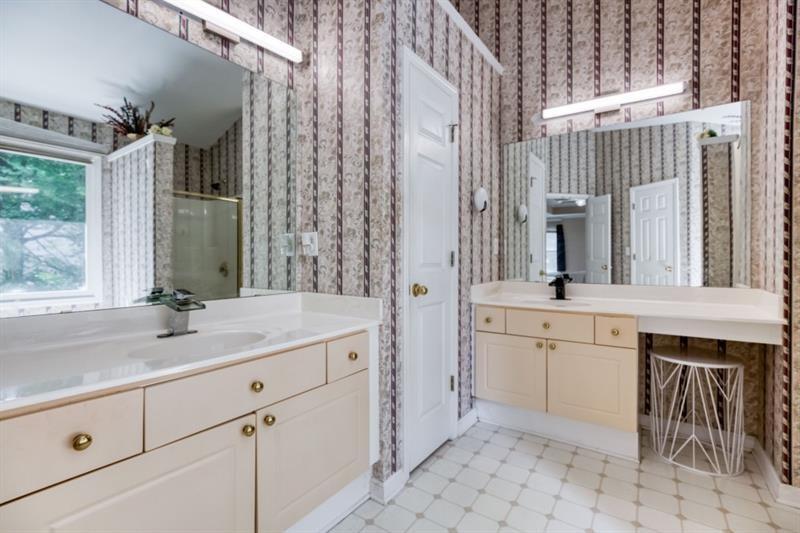 1008 Post Horn Run Lawrenceville, GA 30045 - Photo 20 of 64 a spacious bathroom with a granite countertop sink mirror and a