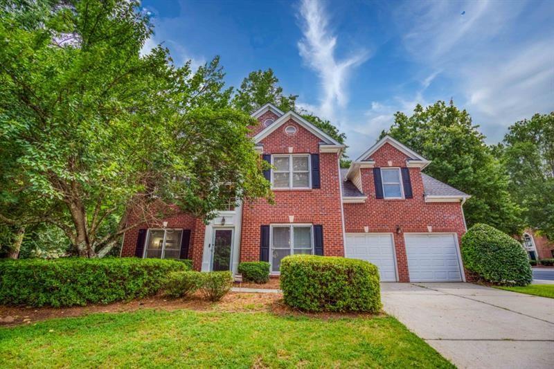 1008 Post Horn Run Lawrenceville, GA 30045 - Photo 2 of 64 a front view of a house with a yard and trees