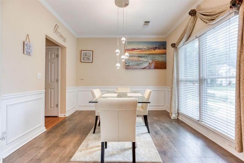 1008 Post Horn Run Lawrenceville, GA 30045 - Photo 46 of 64 a view of a dining room with furniture wooden floor and a chandelier