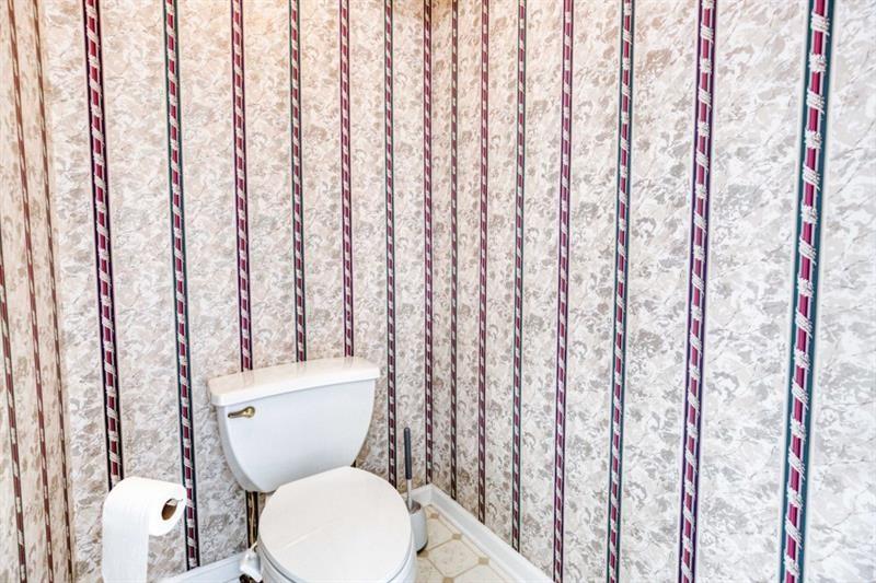 1008 Post Horn Run Lawrenceville, GA 30045 - Photo 51 of 64 a white toilet sitting next to a shower curtain