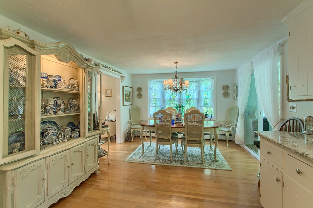 4 Dobson Road Chelmsford, MA 01824 - Photo 8 of 25 a view of a dining room and livingroom with furniture wooden floor a chandelier