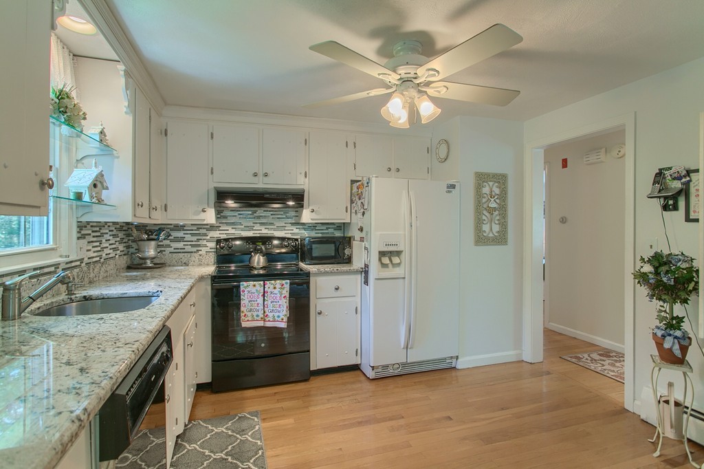 4 Dobson Road Chelmsford, MA 01824 - Photo 10 of 25 a kitchen with granite countertop a sink stove and refrigerator