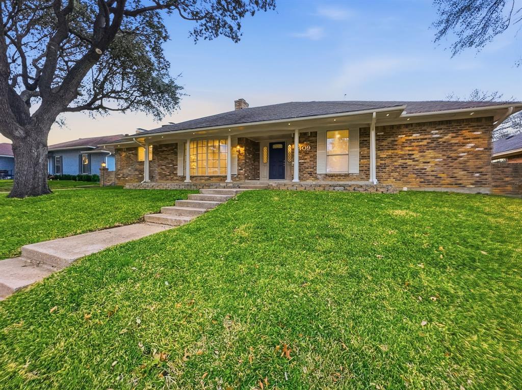 2409 Castle Street Irving, TX 75038 - Photo 1 of 32 a front view of a house with a garden