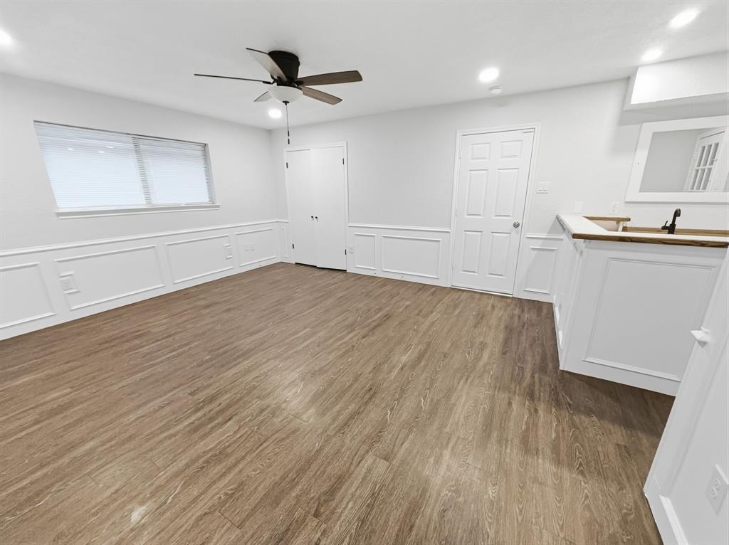 2409 Castle Street Irving, TX 75038 - Photo 15 of 32 an empty room with wooden floor and windows