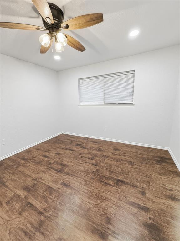 2409 Castle Street Irving, TX 75038 - Photo 19 of 32 an empty room with a window and a ceiling fan