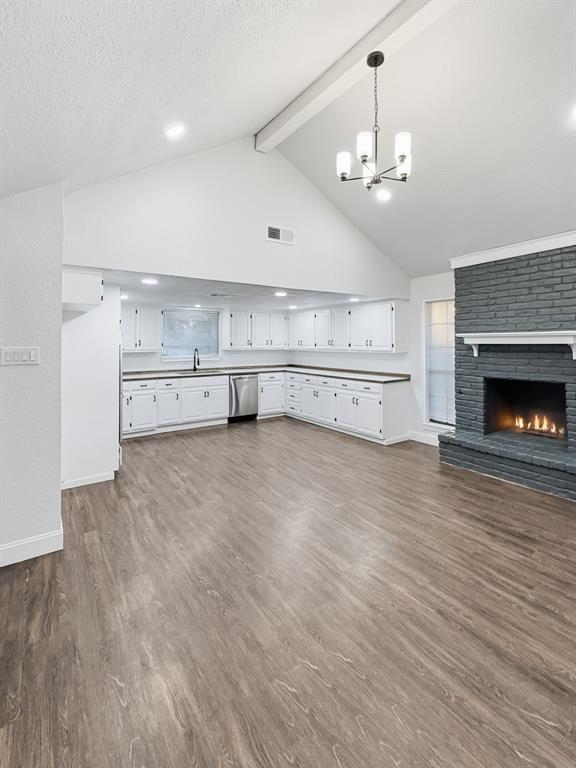 2409 Castle Street Irving, TX 75038 - Photo 22 of 32 a large white kitchen with a stove top oven a sink and dishwasher