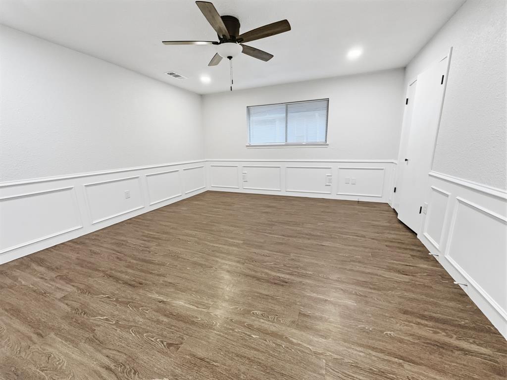 2409 Castle Street Irving, TX 75038 - Photo 23 of 32 wooden floor in an empty room with a window