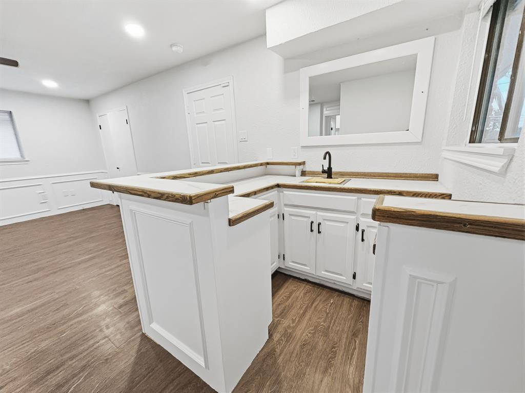 2409 Castle Street Irving, TX 75038 - Photo 24 of 32 a kitchen with a sink stove and cabinets