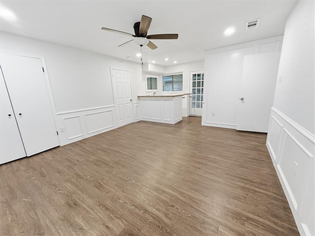 2409 Castle Street Irving, TX 75038 - Photo 26 of 32 a view of an empty room with wooden floor and a window