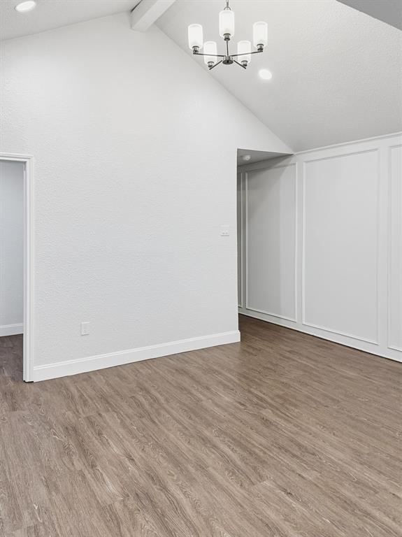 2409 Castle Street Irving, TX 75038 - Photo 10 of 32 a view of an empty room with wooden floor and chandelier