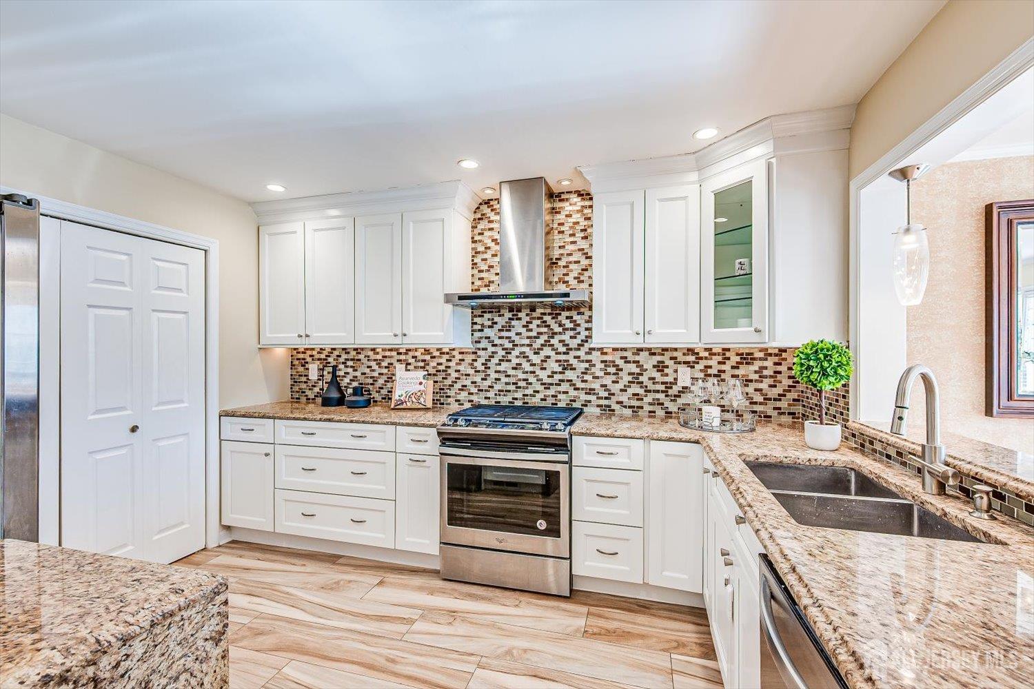52 Springwood Court Princeton, NJ 08540 - Photo 11 of 34 a kitchen with granite countertop a sink stove and cabinets