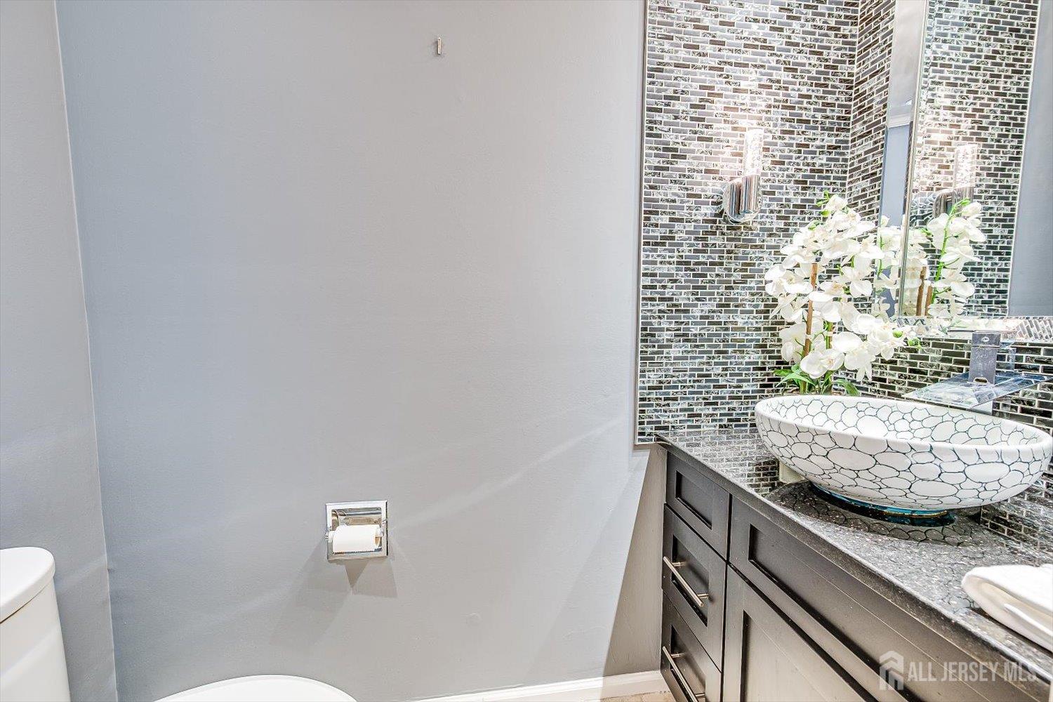 52 Springwood Court Princeton, NJ 08540 - Photo 17 of 34 a bathroom with a granite countertop sink and a toilet