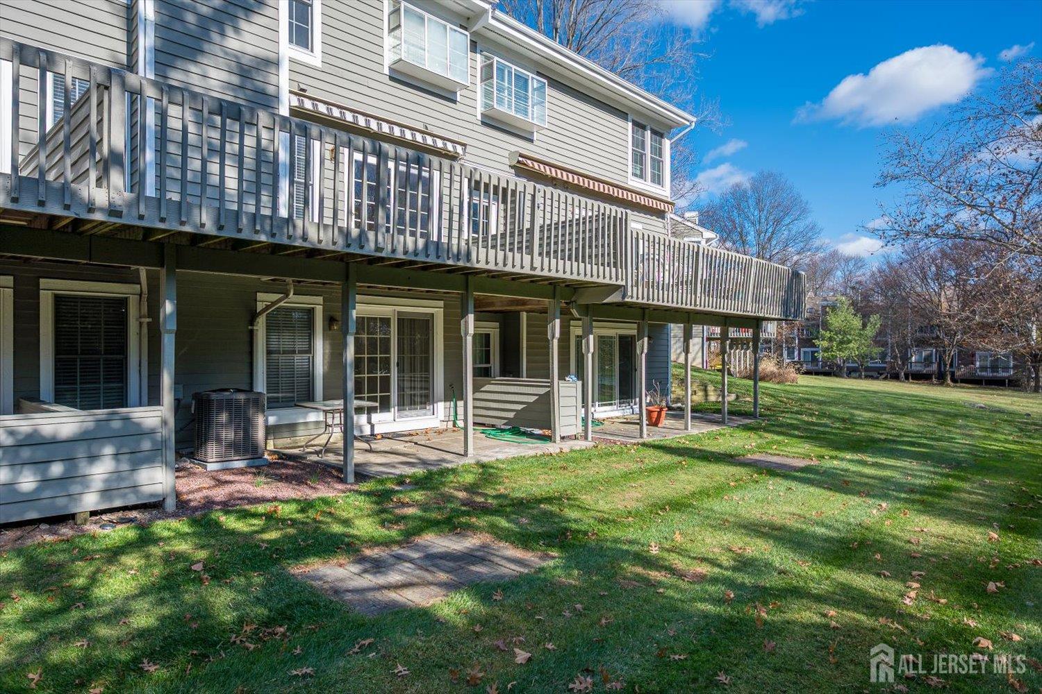 52 Springwood Court Princeton, NJ 08540 - Photo 3 of 34 a front view of a building with table and chairs and garden