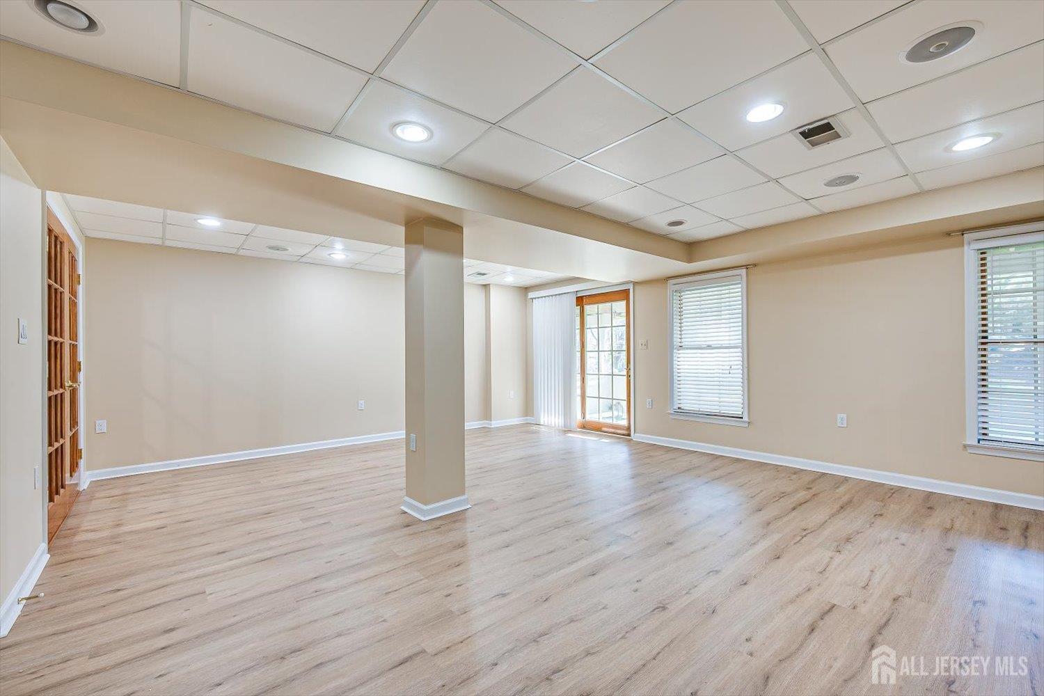 52 Springwood Court Princeton, NJ 08540 - Photo 32 of 34 a view of an empty room with wooden floor and a window