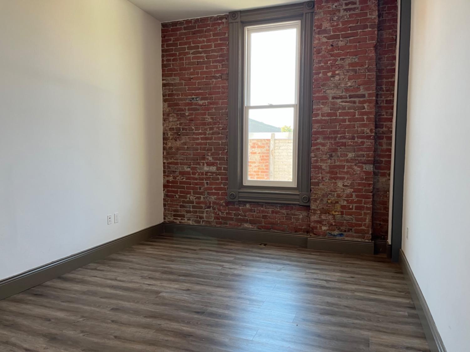 401 2nd Street, Unit 206 Woodland, CA 95695 - Photo 11 of 27 an empty room with wooden floor and windows