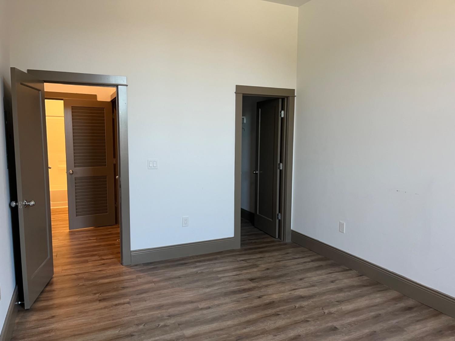 401 2nd Street, Unit 206 Woodland, CA 95695 - Photo 12 of 27 an empty room with wooden floor and closet