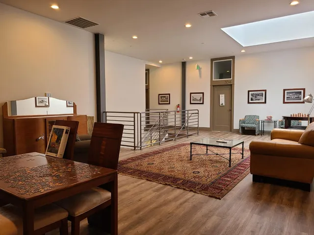 a living room with furniture rug and wooden floor
