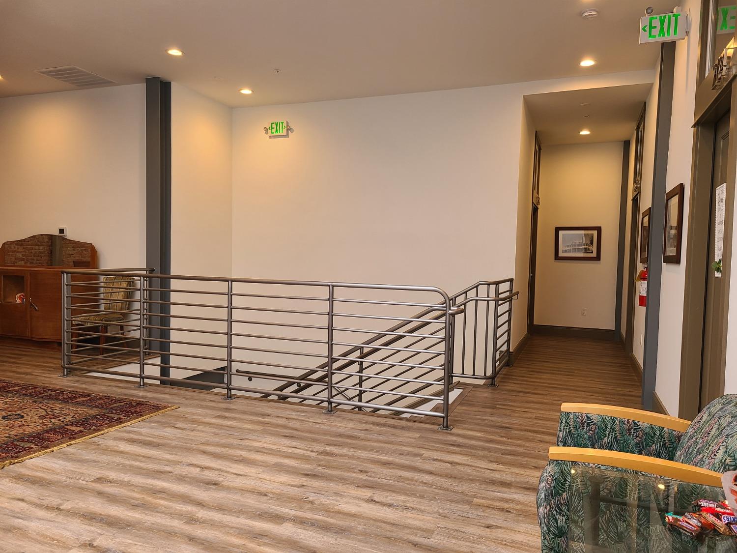 401 2nd Street, Unit 206 Woodland, CA 95695 - Photo 18 of 27 a view of a hallway with wooden floor and stairs