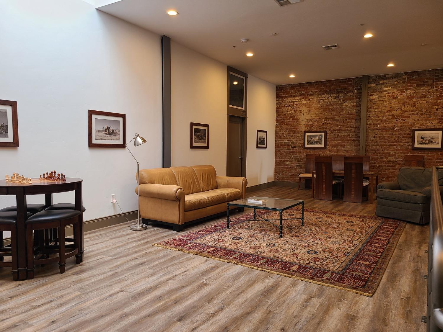 401 2nd Street, Unit 206 Woodland, CA 95695 - Photo 19 of 27 a living room with furniture and wooden floor