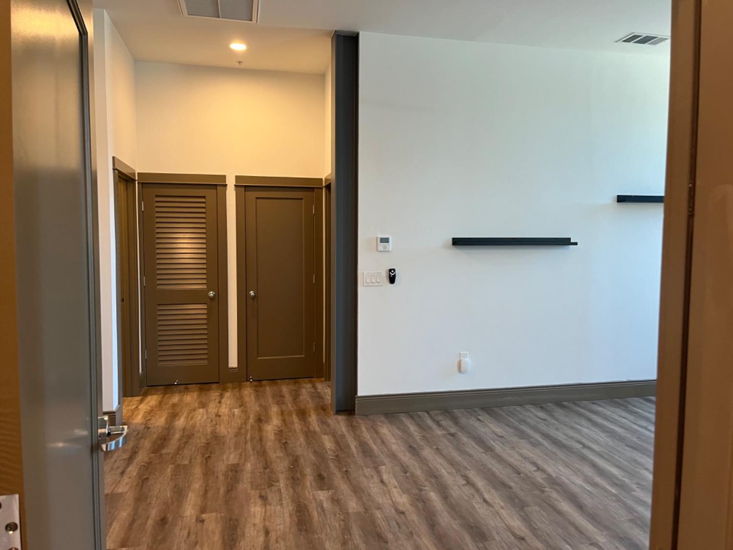 401 2nd Street, Unit 206 Woodland, CA 95695 - Photo 3 of 27 an empty room with wooden floor and entrance