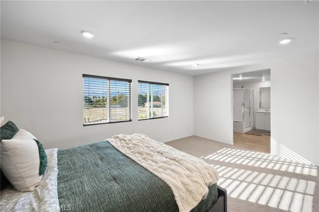 a bathroom with a double vanity sink mirror and shower