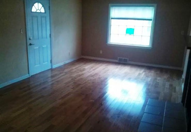 4305 Newburg Road Rockford, IL 61108 - Photo 3 of 11 an empty room with wooden floor and windows