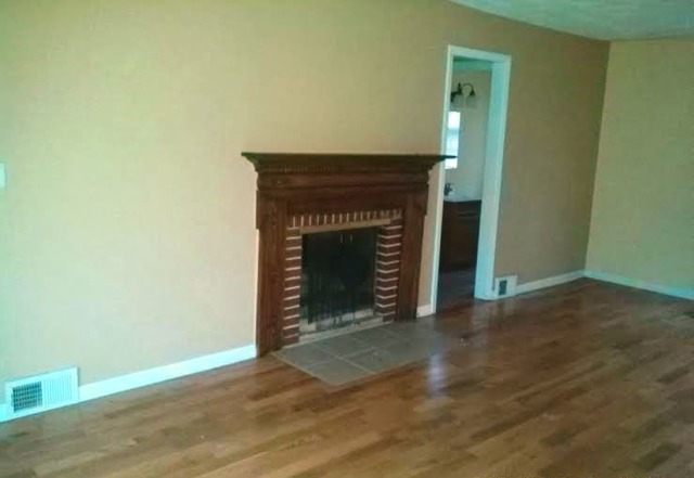 4305 Newburg Road Rockford, IL 61108 - Photo 4 of 11 a view of empty room with wooden floor and fireplace