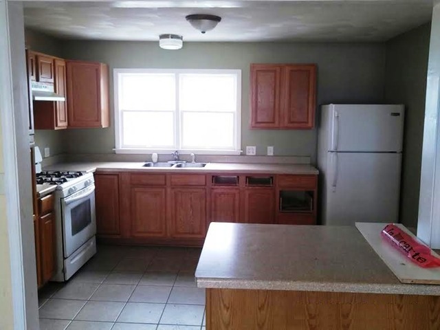 4305 Newburg Road Rockford, IL 61108 - Photo 7 of 11 a kitchen with a sink stove and refrigerator