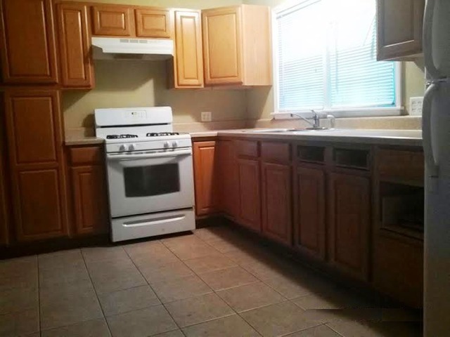 4305 Newburg Road Rockford, IL 61108 - Photo 8 of 11 a kitchen with a stove sink and cabinets