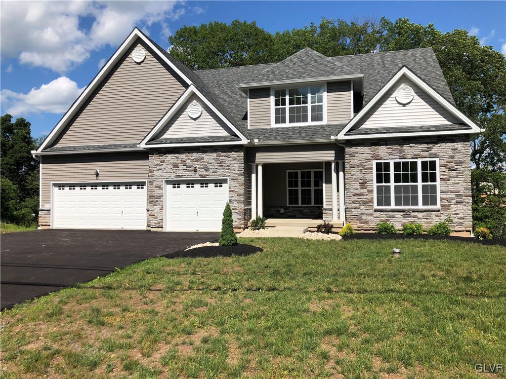 6559 Gun Club Road, Unit 35 Coopersburg, PA 18036 - Photo 1 of 48 a view of a yard in front of a house with a large tree