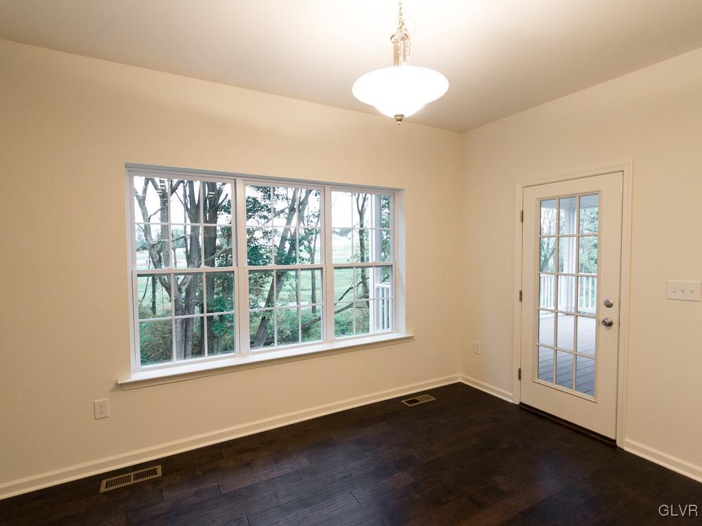 6559 Gun Club Road, Unit 35 Coopersburg, PA 18036 - Photo 14 of 48 a view of an empty room with wooden floor and a window