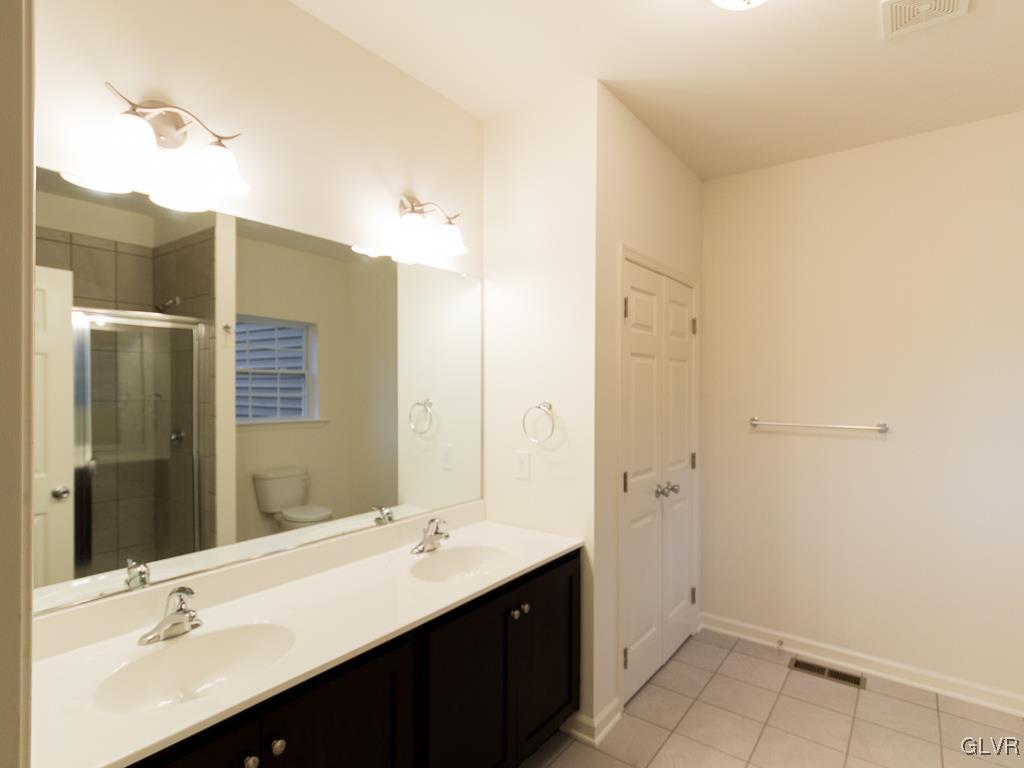 6559 Gun Club Road, Unit 35 Coopersburg, PA 18036 - Photo 30 of 48 a bathroom with a double vanity sink a and mirror