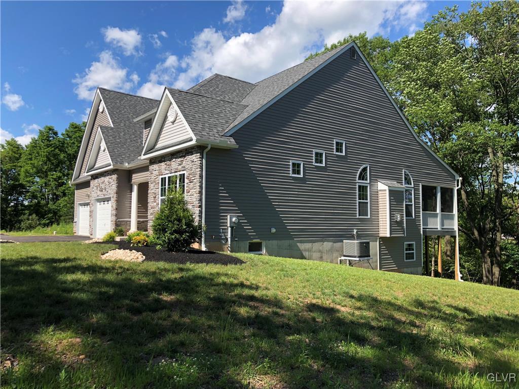 6559 Gun Club Road, Unit 35 Coopersburg, PA 18036 - Photo 3 of 48 a front view of a house with a yard