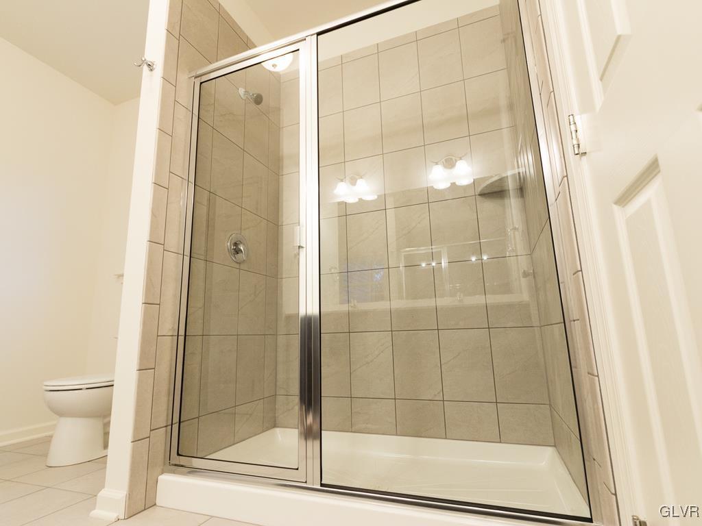 6559 Gun Club Road, Unit 35 Coopersburg, PA 18036 - Photo 31 of 48 a bathroom with a shower and a toilet