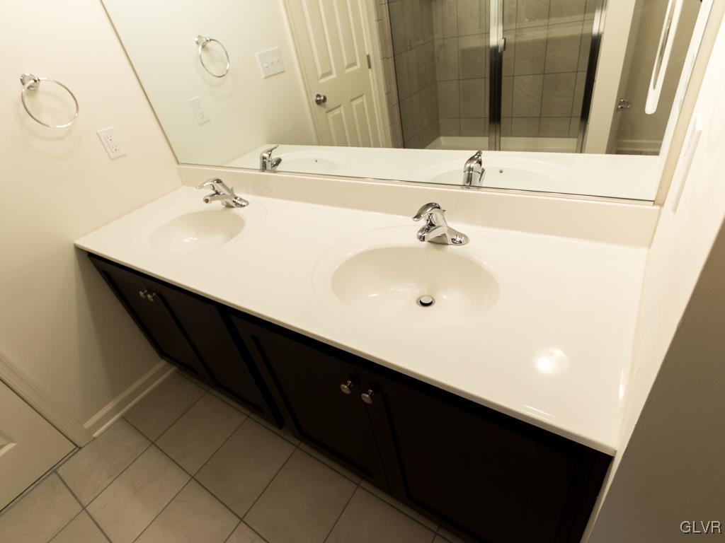 6559 Gun Club Road, Unit 35 Coopersburg, PA 18036 - Photo 32 of 48 a bathroom with a double vanity sink and a mirror