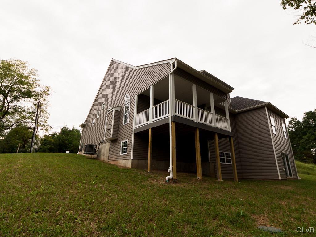 6559 Gun Club Road, Unit 35 Coopersburg, PA 18036 - Photo 4 of 48 a front view of a house with a yard