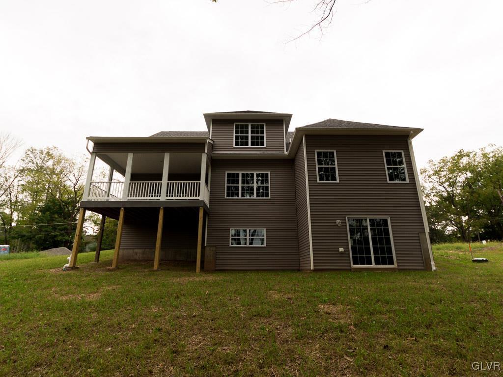 6559 Gun Club Road, Unit 35 Coopersburg, PA 18036 - Photo 5 of 48 a front view of a house with a garden