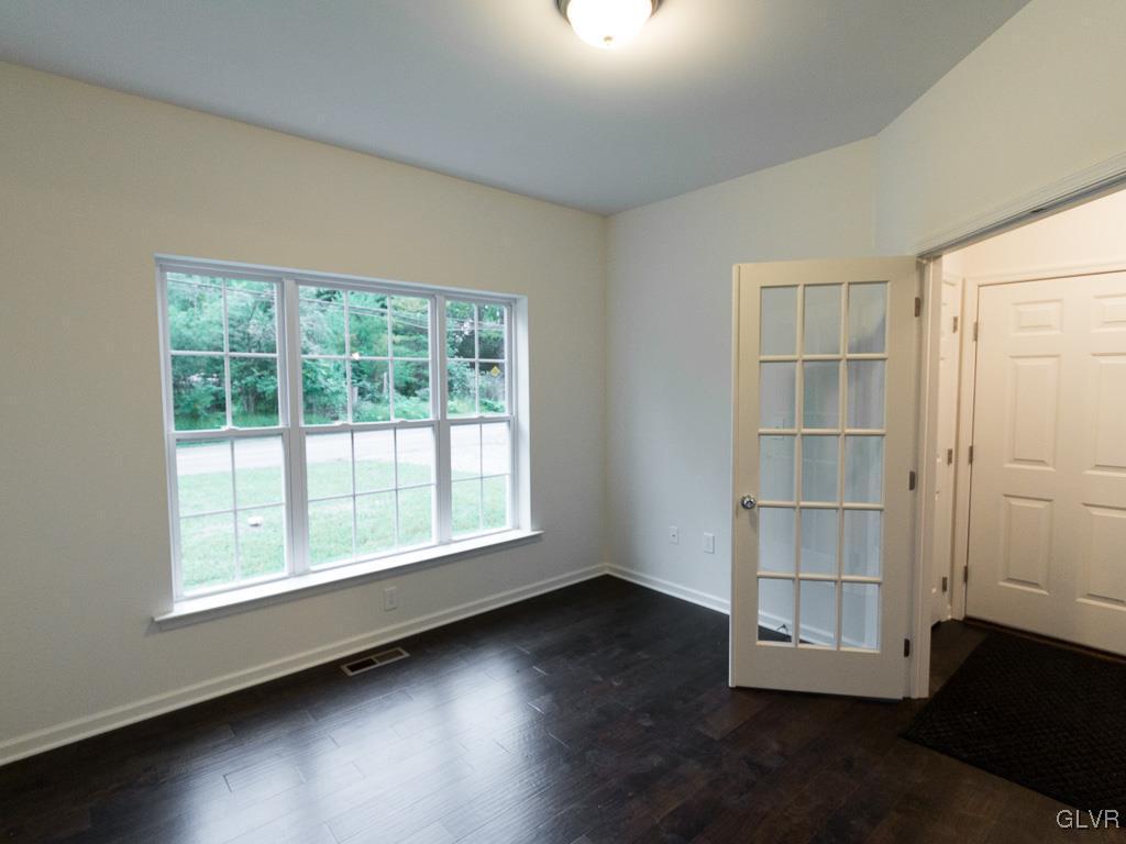 6559 Gun Club Road, Unit 35 Coopersburg, PA 18036 - Photo 7 of 48 an empty room with wooden floor and windows