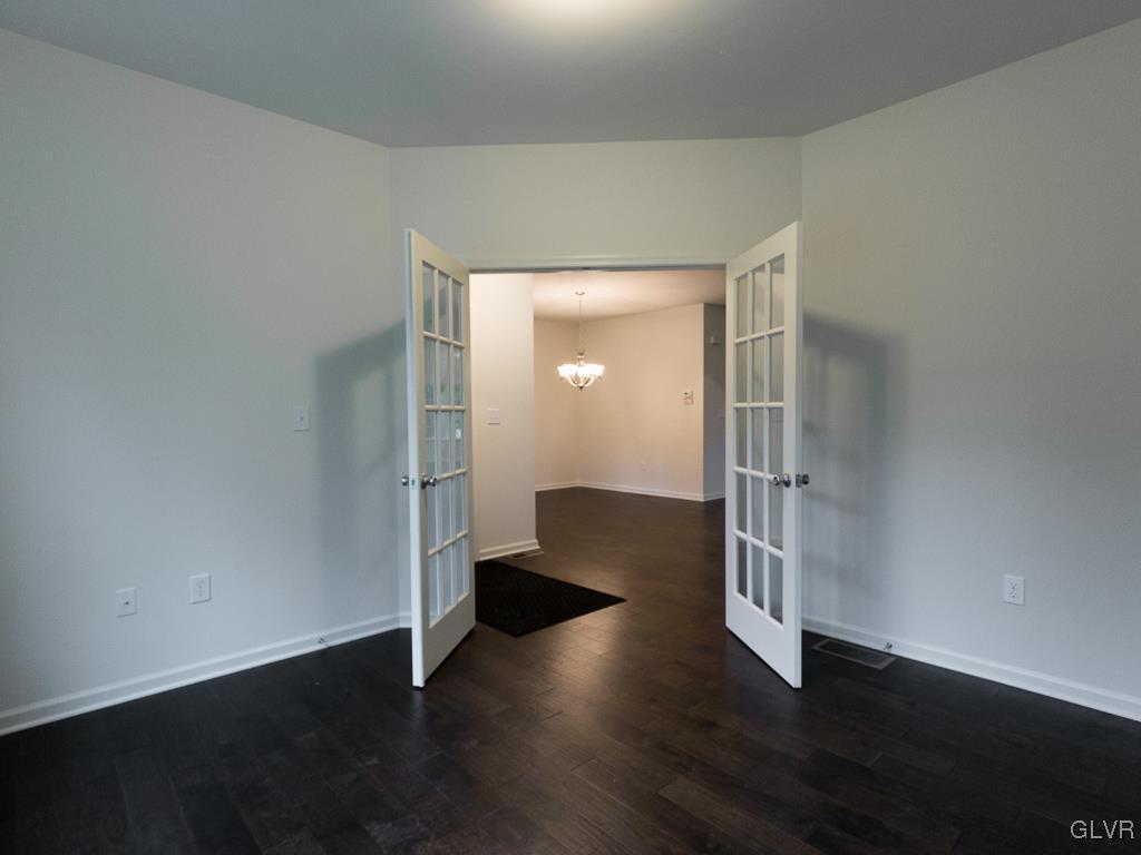 6559 Gun Club Road, Unit 35 Coopersburg, PA 18036 - Photo 8 of 48 an empty room with wooden floor and windows