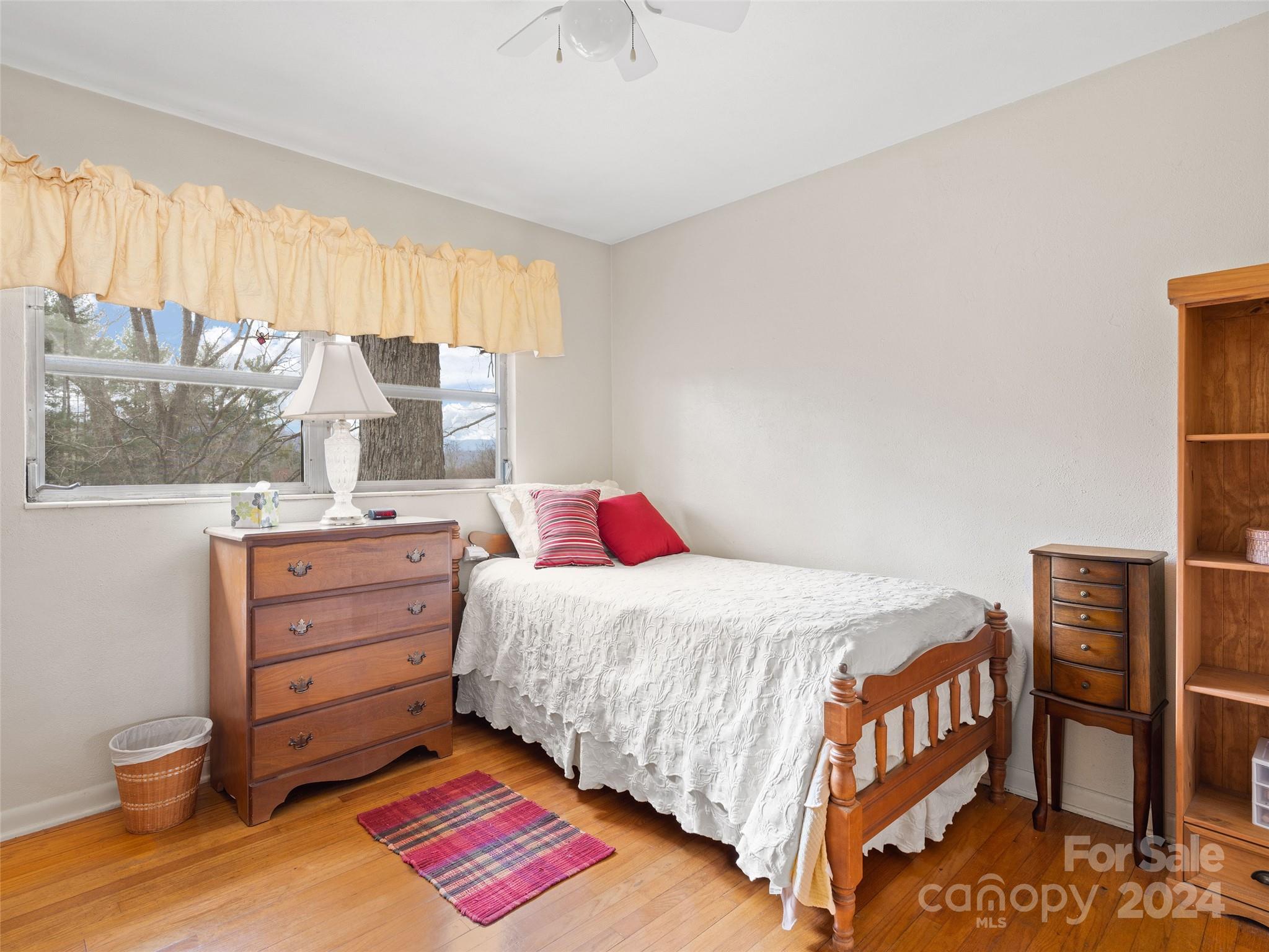 2599 Thickety Road Clyde, NC 28721 - Photo 18 of 30 a bedroom with a bed and a baby crib