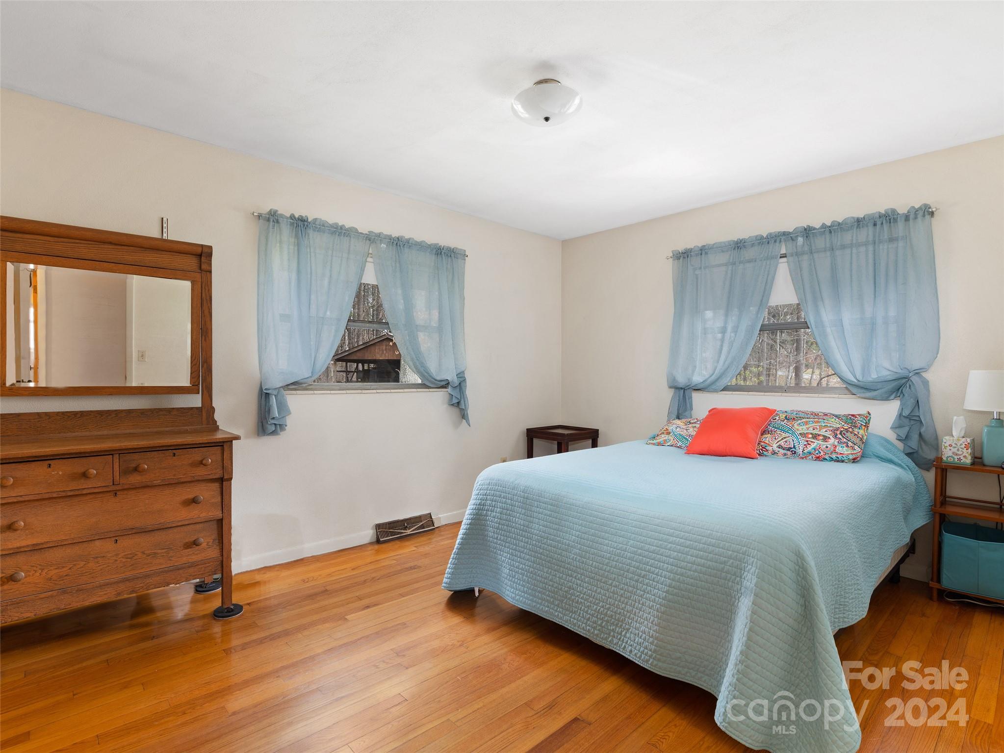 2599 Thickety Road Clyde, NC 28721 - Photo 20 of 30 a bedroom with a bed and a dresser