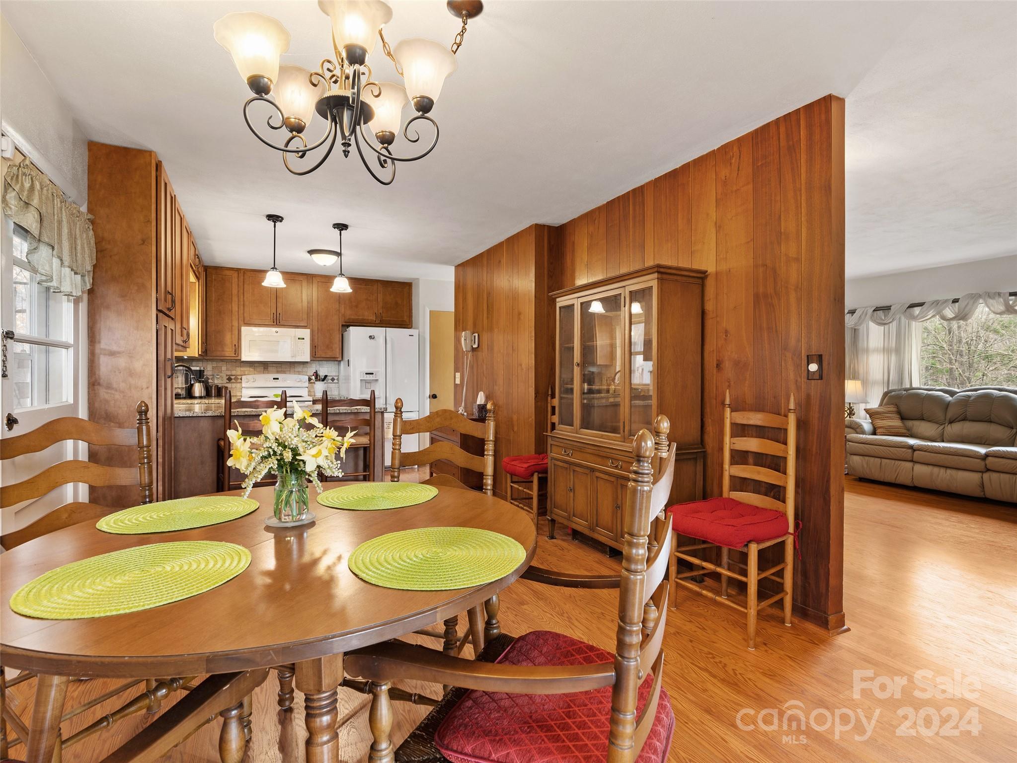 2599 Thickety Road Clyde, NC 28721 - Photo 8 of 30 a view of a dining room with furniture a chandelier and wooden floor