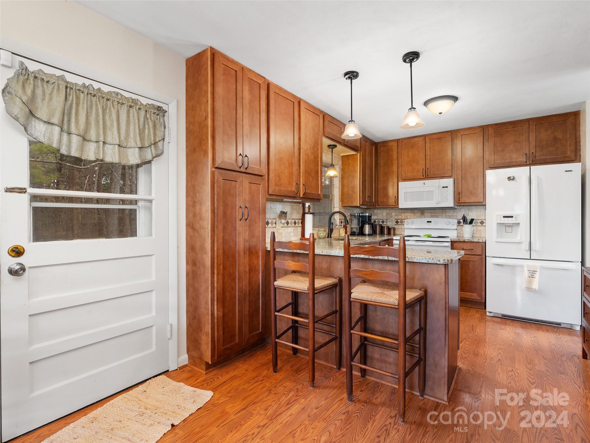 2599 Thickety Road Clyde, NC 28721 - Photo 10 of 30 a kitchen with refrigerator a microwave and white appliances