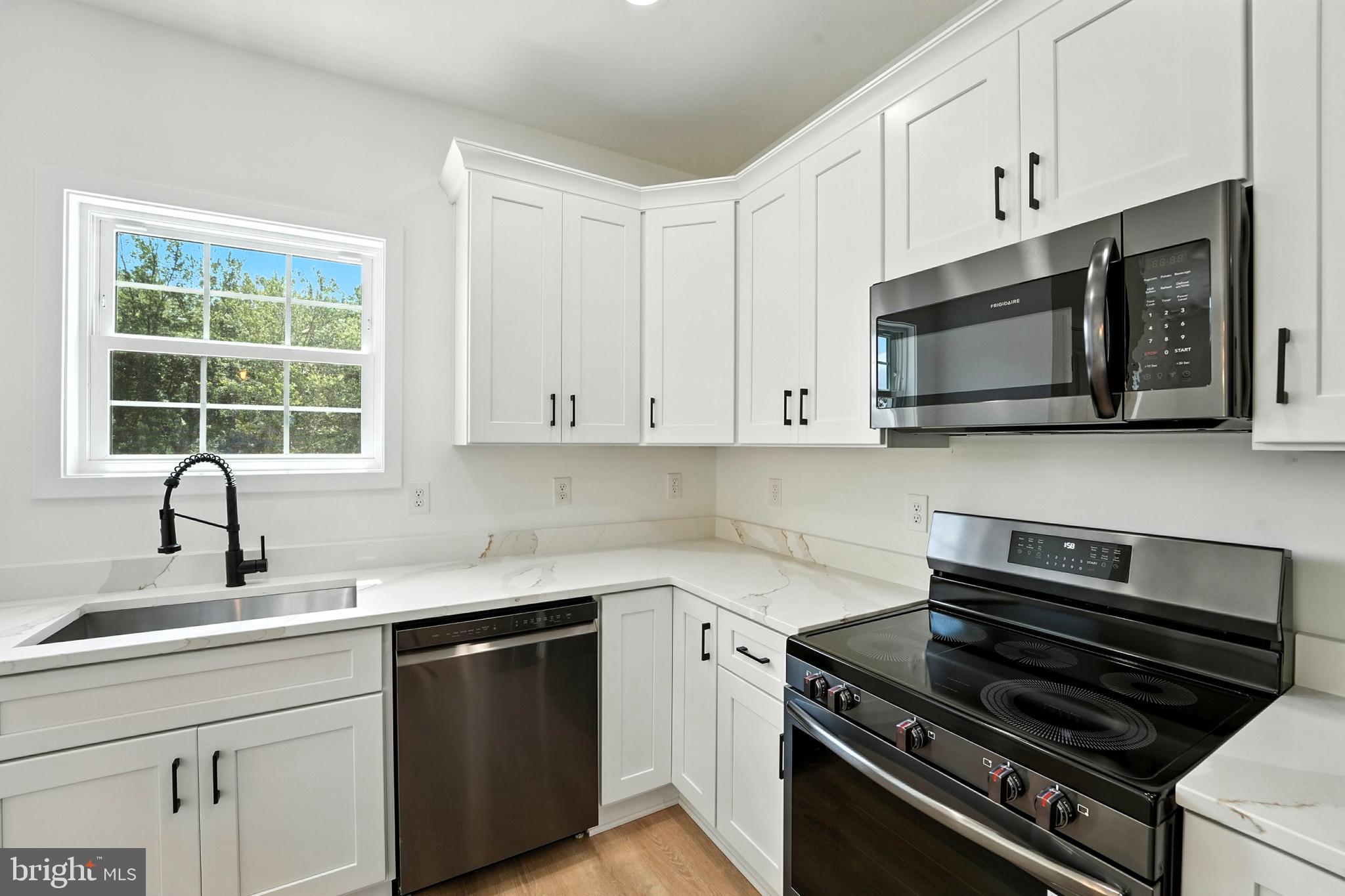 10446 Cherry Hill Road Culpeper, VA 22701 - Photo 11 of 53 a kitchen with stainless steel appliances a sink dishwasher stove microwave and cabinets