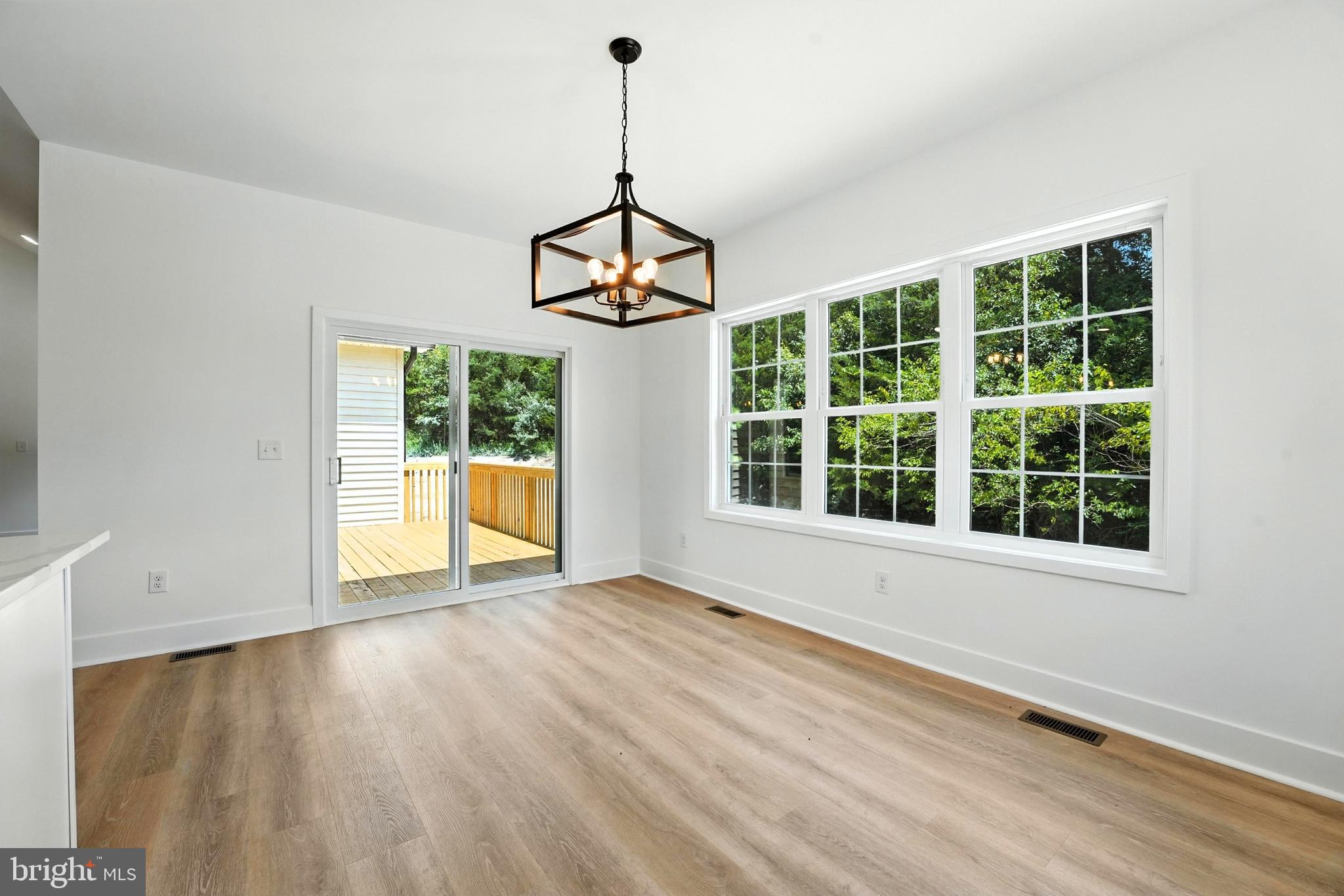 10446 Cherry Hill Road Culpeper, VA 22701 - Photo 16 of 53 a view of an empty room with a window and wooden floor