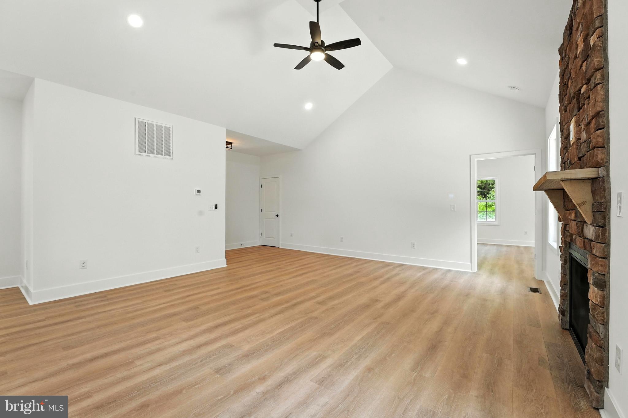 10446 Cherry Hill Road Culpeper, VA 22701 - Photo 18 of 53 an empty room with wooden floor and ceiling fan
