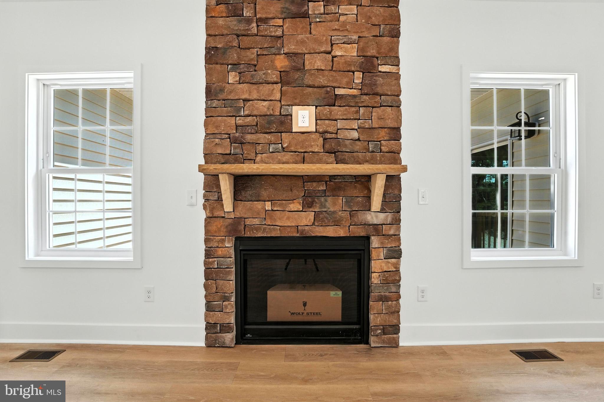10446 Cherry Hill Road Culpeper, VA 22701 - Photo 19 of 53 a living room with a fireplace and windows