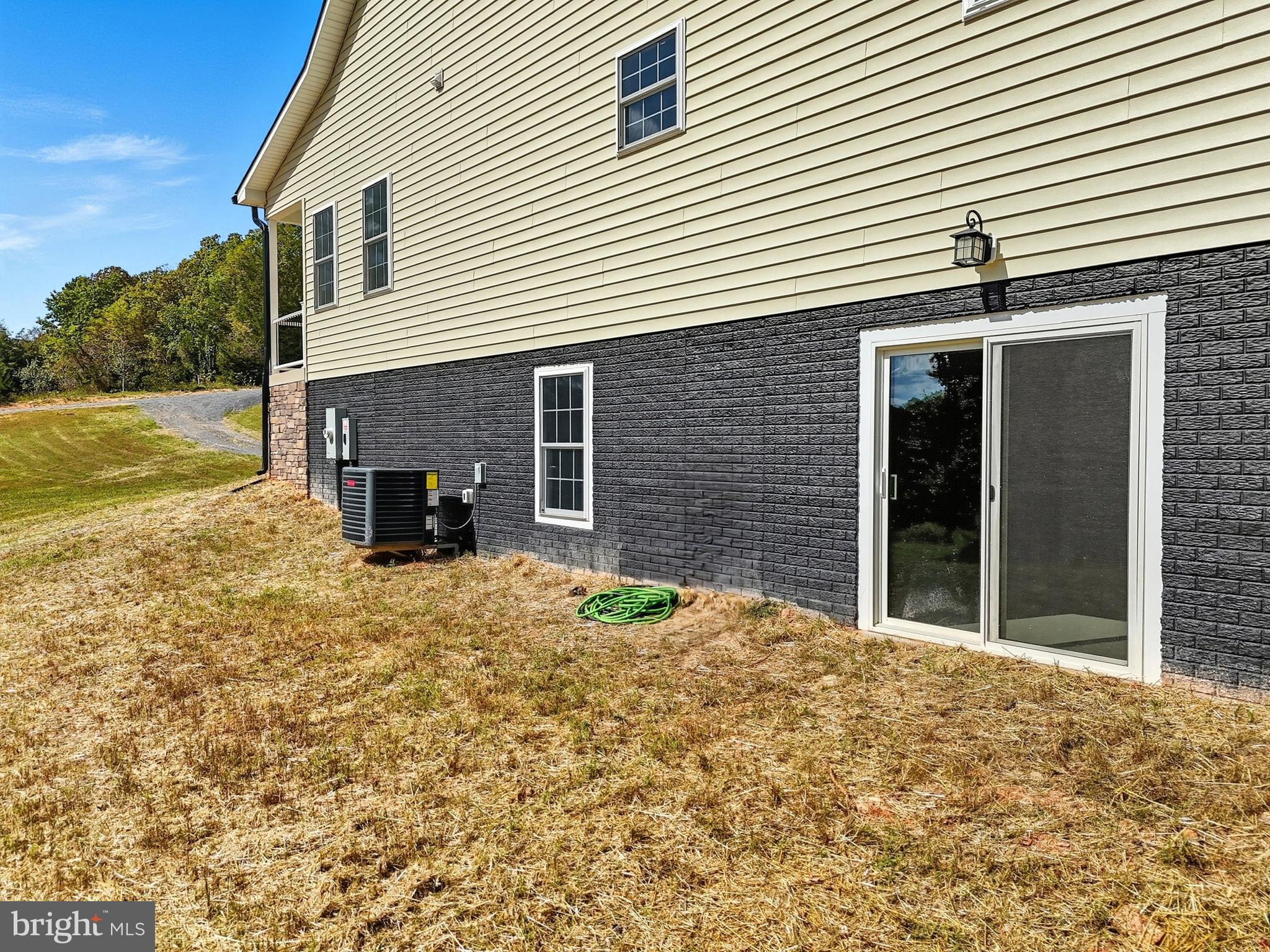 10446 Cherry Hill Road Culpeper, VA 22701 - Photo 52 of 53 a view of a house with a patio and backyard